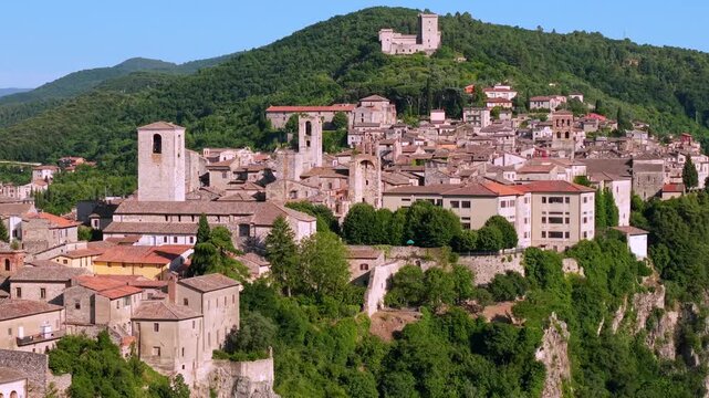 Narni Umbria Italy 4K Aerial. Drone 70mm sideways flight by tufa cliff revealing historic medieval hilltop town with fortress towers. Authentic secret travel paradise landscape hidden gems asset