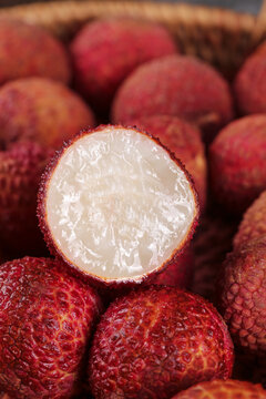 Fresh Hainan Lychees Cut Open Showing White Flesh and Red Skin