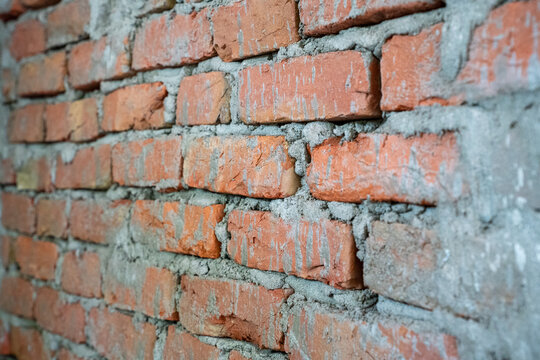 Red brick wall texture with rough cement mortar