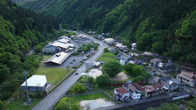 Aerial drone footage of mountain valley village and road in Yuki Onsen, Hiroshima