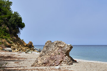 A boulder on the rocky coast of the Aegean Sea, Greece © GKor