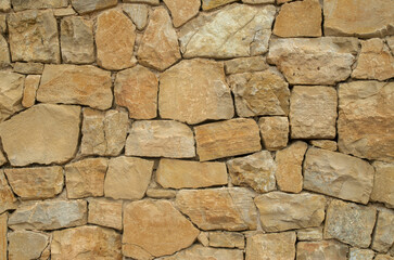 Fototapeta premium Yellow stone wall close up