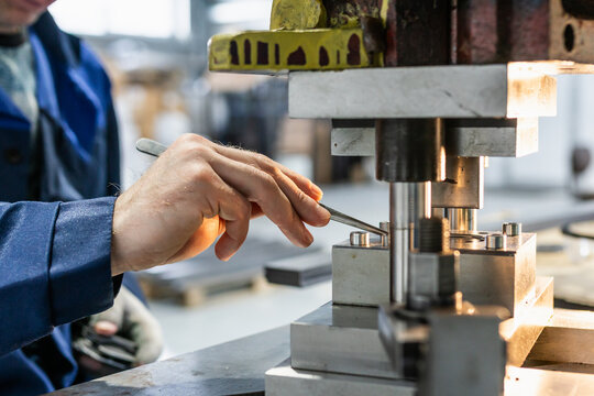 Industrial press mold in operation, precision metal forming equipment inside manufacturing workshop, focus on factory production process