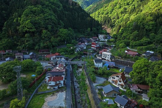 Aerial drone photo of Yuki Onsen hot spring village nestled in green mountains, Hiroshima, Japan