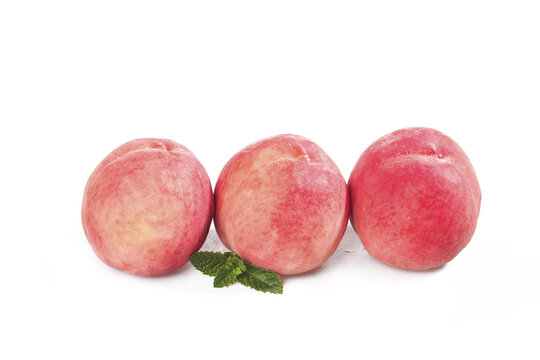 Fresh Red Peaches with Water Droplets and Mint Leaves