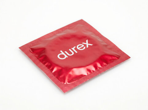 Durex condom packet on white background sexual health product close up
