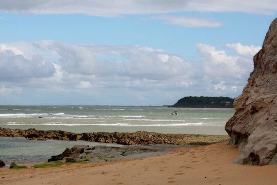 Praia do Espelho (Mirror beach) in Trancoso, Bahia in calm sea , empty shore, blue sky with few clouds