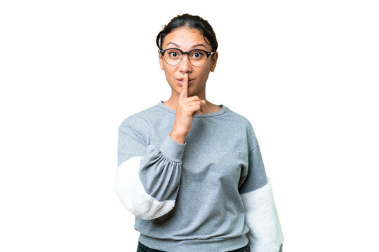 Young Uruguayan woman over isolated chroma key background showing a sign of silence gesture putting finger in mouth