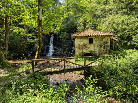Molin de la Pe&ntilde;a, old watermill beside a small waterfall on PR-AS-137 (R&iacute;o Profundo mills route), rustic stone building in lush forest by a stream, Villaviciosa municipality, Asturias, Spain