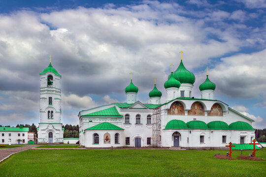 Transfiguration Cathedral apse and belfry in Svirskoye, Russia. Historic stone monastery architecture, white walls