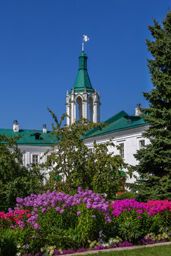 Spaso Yakovlevsky Monastery corner tower in Rostov, Russia. Historic stone architecture, view from garden with flowers
