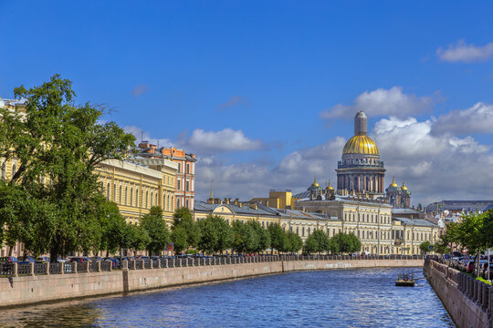 Moyka River embankment in St Petersburg, Russia. Historic cityscape with St Isaacs Cathedral, golden dome view