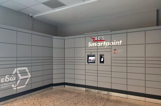 Photo of a room filled with ACS Smartpoint automated parcel pickup machines. ACS is a Greek company in the courier and postal services sector, with a presence since 1992.