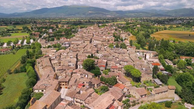 Bevagna Medieval Borgo Aerial Drone Reveal Shot Umbria Italy Narrow River Around Historic Village Dense Stone Architecture Scenic Green Valley Landscape. Cinematic 4K Video Authentic Hidden gems