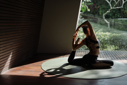 Graceful Yoga Practice in Sunlit Tropical Studio