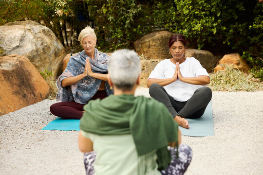 Women Practice Yoga Outdoors During Vacation