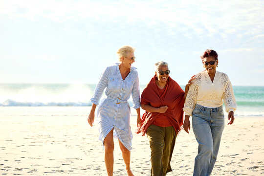 Friends Walk on the Beach During the Day