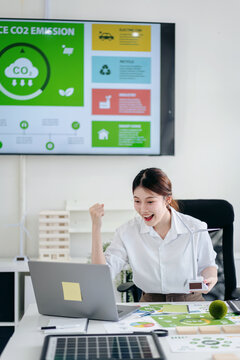 Excited Young Woman Celebrates Carbon Emission Reduction Success