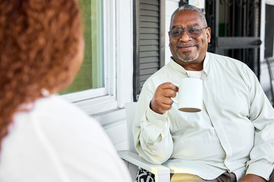 Couple Sips Coffee on Porch
