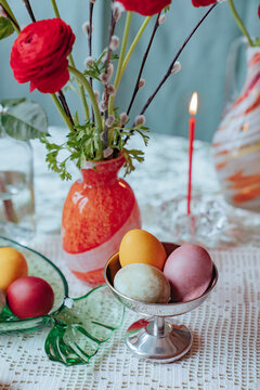 Colorful eggs and flowers on a table during a spring celebration