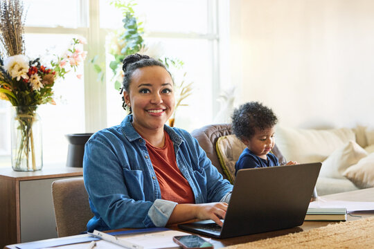 Parent Works at Home While Child Plays Nearby