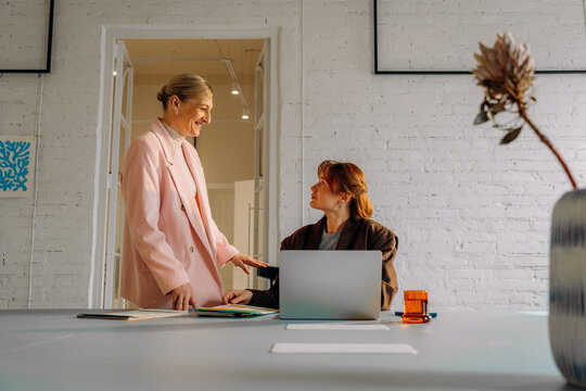 A woman uses a laptop in the office