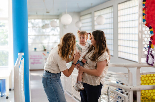Women interacting with child in early childhood education