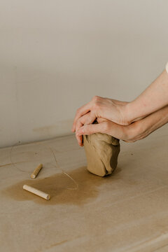 Shaping and cutting clay with hand for pottery