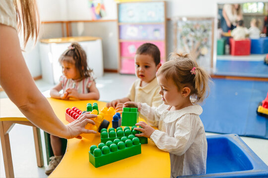 Preschool children playing with colorful building 