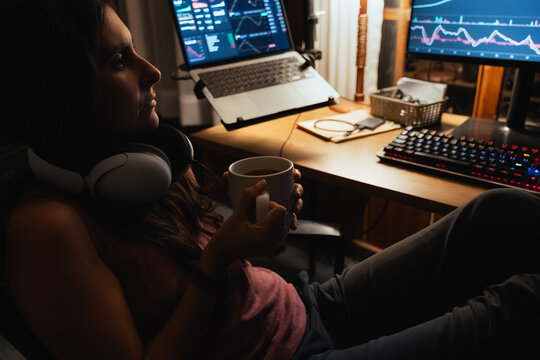 woman Trading and analysing financial Stock charts on Multiple Screens
