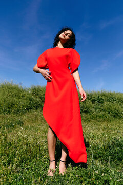 Woman posing in red fashion dress outdoor