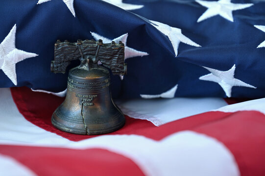 A liberty bell replica on an American Flag for the 250th anniversary semiquincentennial aka sestercentennial 