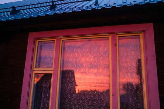 Sunset Reflections on a Window in a Rural Setting