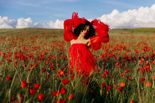 Woman in red dress with raised arms