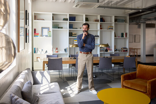 BusinessMan Stands in Modern Office Setting