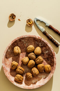 Walnuts on a plain beige surface
