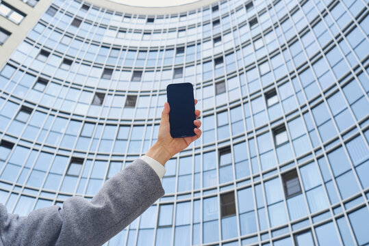 Woman holding a mobile phone with blank screen
