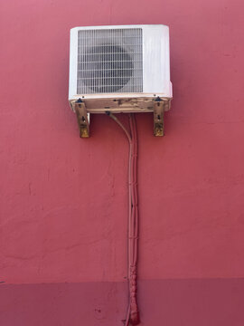 Air Conditioning Unit On Pink Building Wall