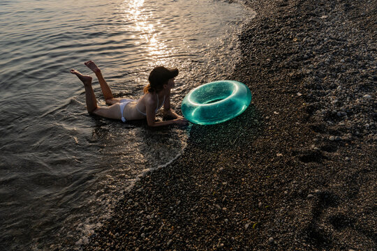 Young woman on the beach in backlight

