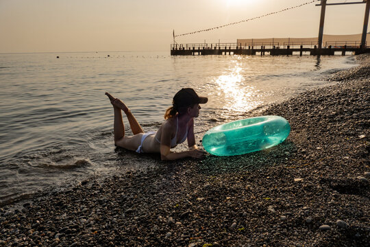 Young woman on the beach in backlight

