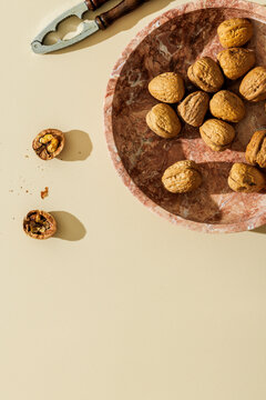Walnuts on a plain beige surface