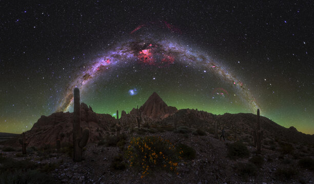 Full Milky Way arch above desert mountains and cacti near Purmamarca, 