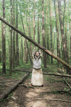 Person touching a fallen tree branch in a forest setting