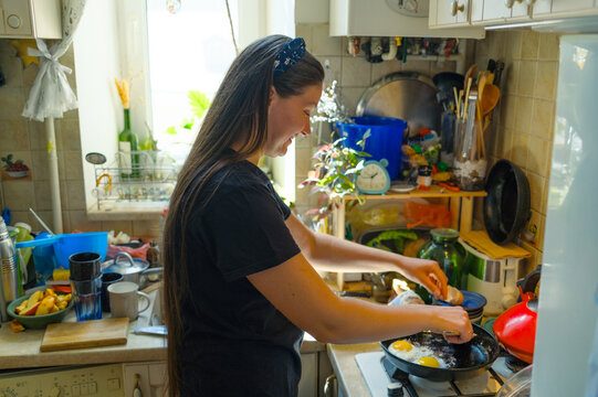 Woman cooking breakfast in the kitchen