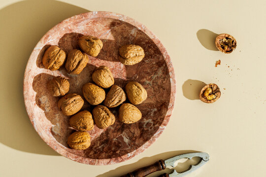Walnuts on a plain beige surface