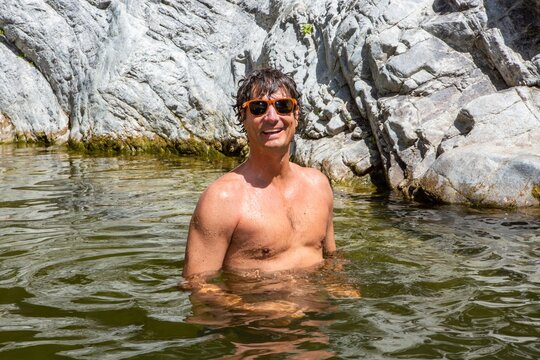 Happy Man Enjoying a Remote Swimming Hole