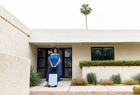 Black woman luggage Portrait home front door outdoors 