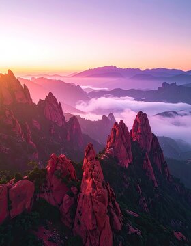 Majestic mountain peaks bathed in the soft hues of a sunrise.