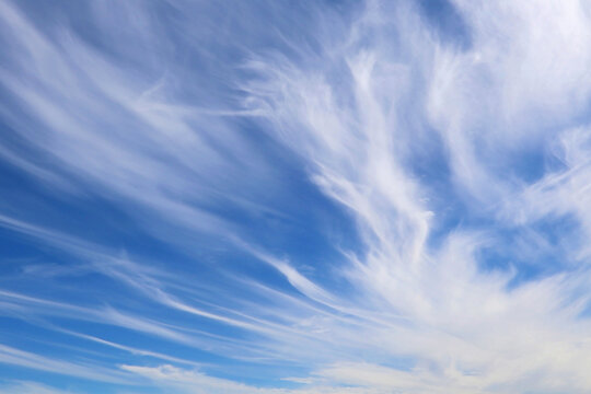 Beautiful blue sky with wispy white cirrus clouds on a sunny day