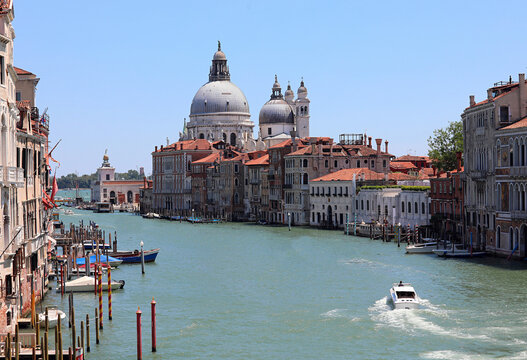 Beautiful cityscape of Venice with Grand Canal and Santa Maria della Salute dome under blue sky